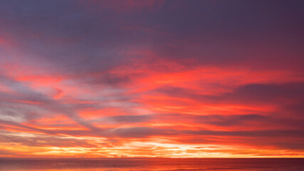 Naklejka na ściany i meble Sunset over the sea. Nature and travel concept