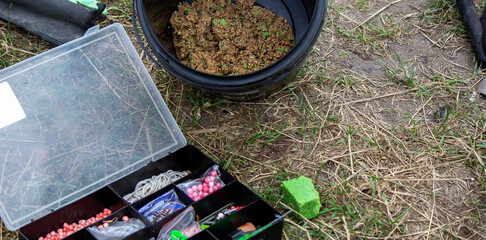 Fishing tackle on the river bank, bait rod, spinning rod, fish. Selective focus
