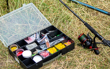 Fishing tackle on the river bank, bait rod, spinning rod, fish. Selective focus