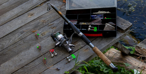 Fishing tackle on the river bank, bait rod, spinning rod, fish. Selective focus