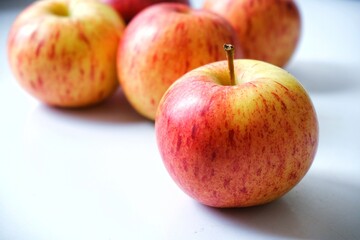Gala apples with sunshine and white background.