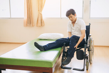 People with disabilities transfer from bed to wheelchair. Rehabilitation with physical therapy and...