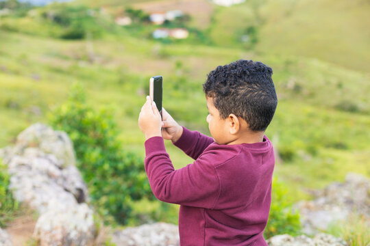 boy with mobile taking pictures