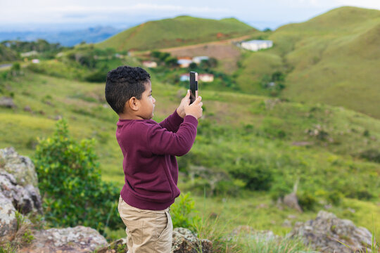 boy with mobile taking pictures