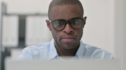 Close Up of African Man using Laptop 