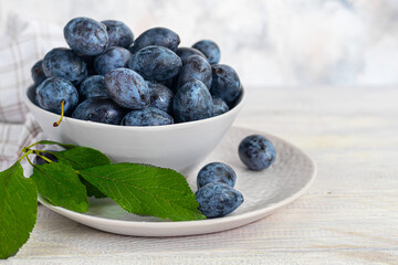 Plums on a light background. Harvesting the autumn harvest. Making jam and sauce. Still life.