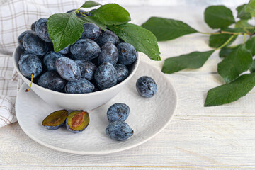 Plums on a light background. Harvesting the autumn harvest. Making jam and sauce. Still life.