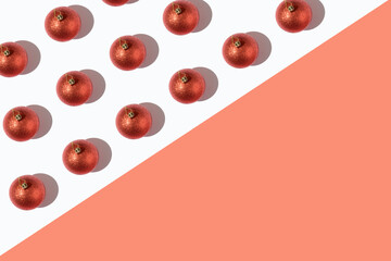 Red sequined Christmas balls pattern on a red and white background. Minimal aesthetic concept. New Year's mood.