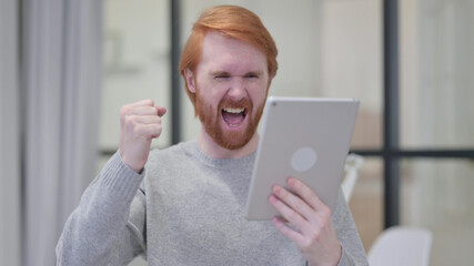 Successful Beard Redhead Man Celebrating on Tablet