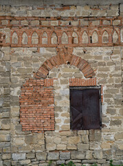 Old brickwork, medieval house with closed window openings.