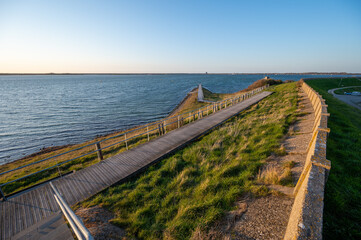 Obraz premium Walking in Scharendijke, small town in Zealand, Netherlands with old houses and blue water of Grevelingenmeer