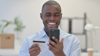 Online Shopping on Smartphone by African Man