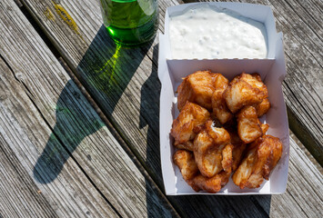 Deep fried cod fish in pieces served outdoor with tartar sauce - obrazy, fototapety, plakaty