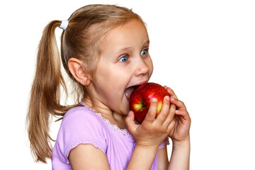 Satisfied girl eats an apple with pleasure on a white background