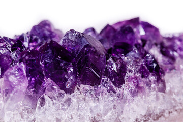 Macro mineral stone purple amethyst in crystals on a white background