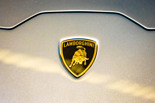 Hamad Airport, Quatar - July 9, 2021: Lamborghini Gold Bull Logo On A Silver Car