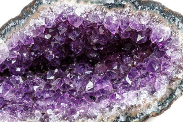 Macro Mineral Stone Amethysts in the rock on a white background