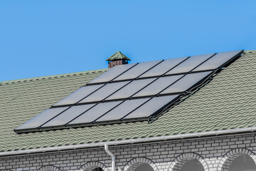 Thermal solar panels alternative technologies of water heating on the roof of the hotel against the blue sky outdoor