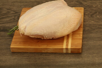 Raw whole chicken breast with skin