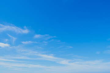 Obraz premium Beautiful clearly deep blue sky with white a little puffy clouds in a sunny day, copyspace