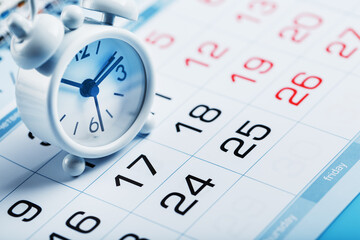 Annual calendar with a white alarm clock on a blue background
