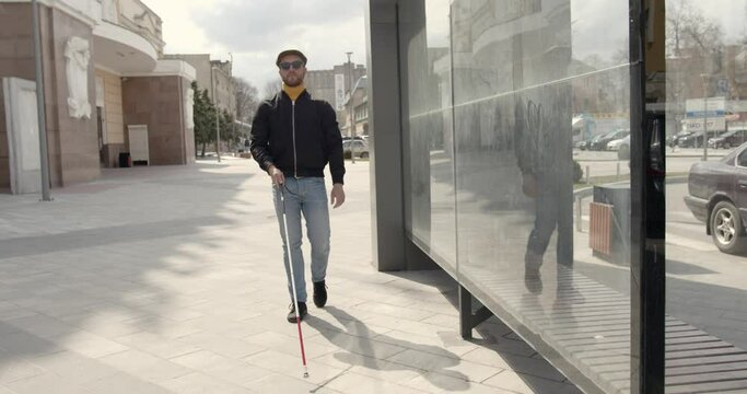 Blind man walking alone in the city