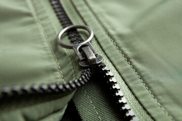 Metal zipper on nylon texture, closeup or macro view. Fastener on jacket 