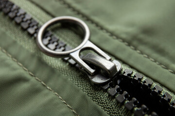 Metal zipper on nylon texture, closeup or macro view. Fastener on jacket 