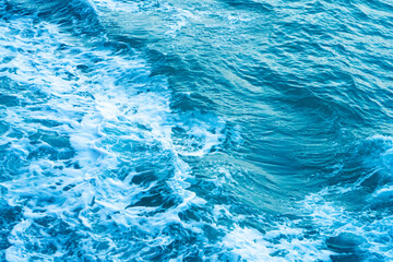 White crest of a wave in the dark turquoise water of the ocean