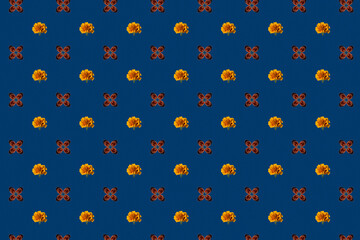 symmetrical seamless pattern of yellow flowers and red ladybugs on a blue background.