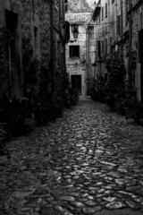 walking through a village in south Europe in black and white 