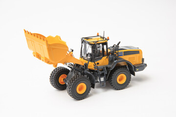 Obraz na płótnie Canvas Highly detailed yellow single-bucket forklift, scale model of specialized equipment on white background, bulk loader.