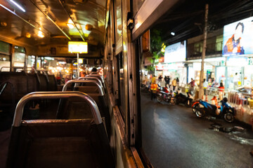 Ride in an empty bus through the city at night. City bus interior. Public transport in Bangkok