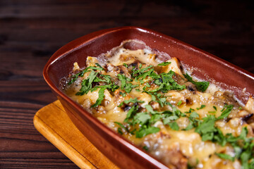 Baked meat with mushrooms and cheese. Al forno. Close-up, selective focus