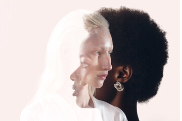 Caucasian woman and african american woman portrait on black background. Women friendship, love and...