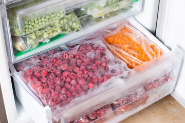 Frozen raspberries in the freezer. Frozen berries.