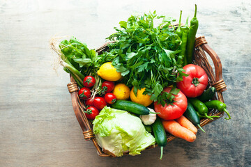 Vegetables in the basket organic vegetables on wooden background