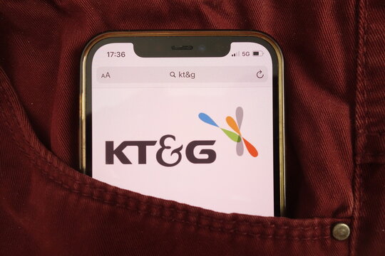 KONSKIE, POLAND - August 17, 2021: Korea Tobacco and Ginseng Corporation logo on mobile phone hidden in jeans pocket