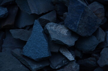 The dark background is composed of sandstone stones in the evening.
