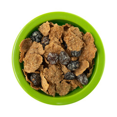 Generic bran flakes with raisins in a green bowl top view.