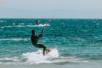 Young man kitesurfing - obrazy, fototapety, plakaty