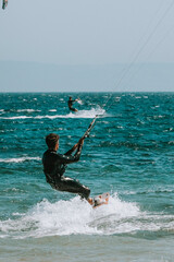 Young man kitesurfing