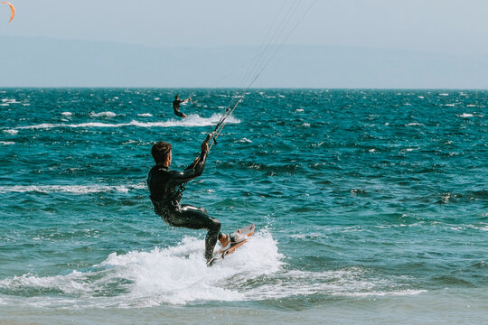 Young man kitesurfing