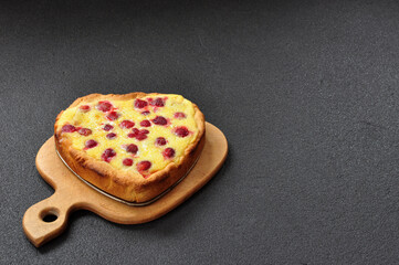 Hot sweet strawberry pie in the shape of heart on Black background with free space for your text