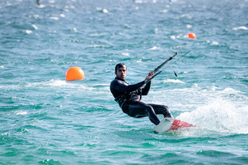 Young man kitesurfing