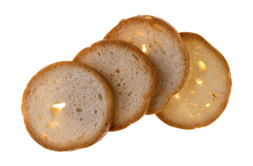 Overhead view of four round toasted crackers on a white background.