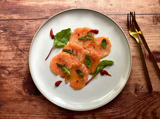 Salmon carpaccio, also known as carpaccio di salmone in olive marinade.