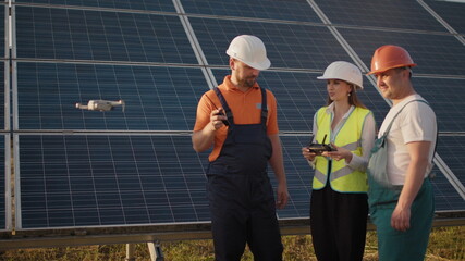 Technician and investor Using Infrared Drone Technology to Inspect Solar Panels and Wind Turbines in Solar cell Farm, Solar cells will be an important renewable energy of the future. Solar panel