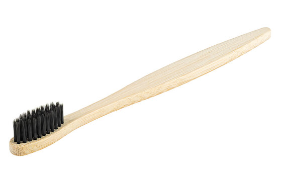 Bamboo wood toothbrush with black brush bristles isolated on a white background. Natural bamboo toothbrush.