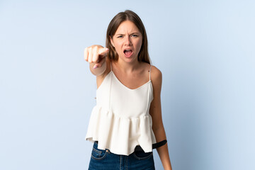 Young Lithuanian woman isolated on blue background frustrated and pointing to the front